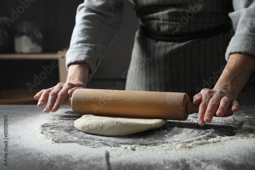 Woman rolling pizza dough with pin at table, closeup © New Africa