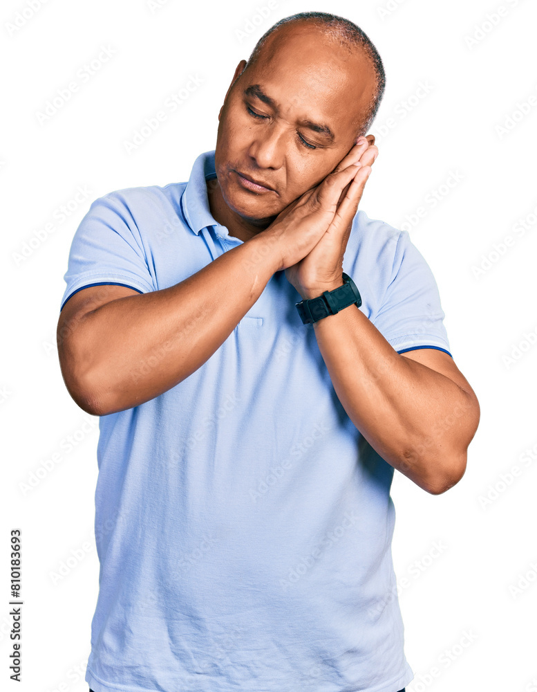 Hispanic middle age man wearing casual t shirt sleeping tired dreaming and posing with hands together while smiling with closed eyes. Hispanic middle age man wearing casual t shirt sleeping tired dreaming and posing with hands together while smiling with closed eyes.