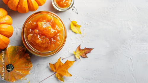 Jar of sweet pumpkin jam on white background