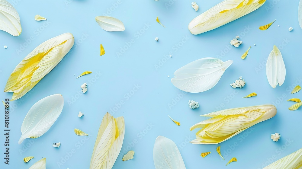 White and yellow endive leaves with crumbled cheese on a blue background. Flat lay composition with copy space. Fresh ingredients and salad concept. Design for poster, menu, and health food promotion White and yellow endive leaves with crumbled cheese on a blue background. Flat lay composition with copy space. Fresh ingredients and salad concept. Design for poster, menu, and health food promotion