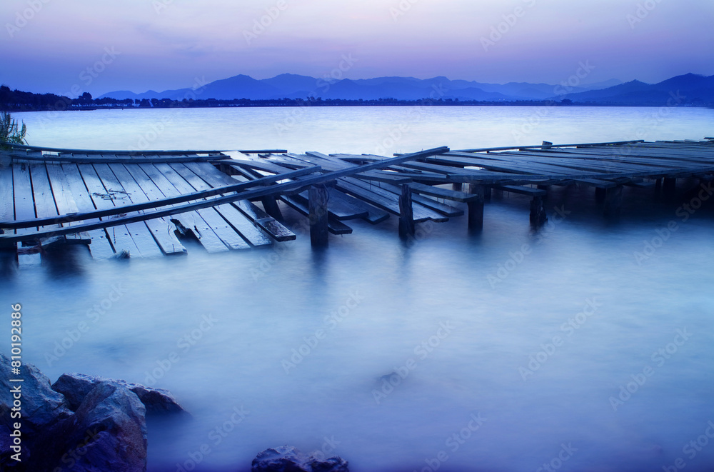 Serene twilight dock over tranquil waters