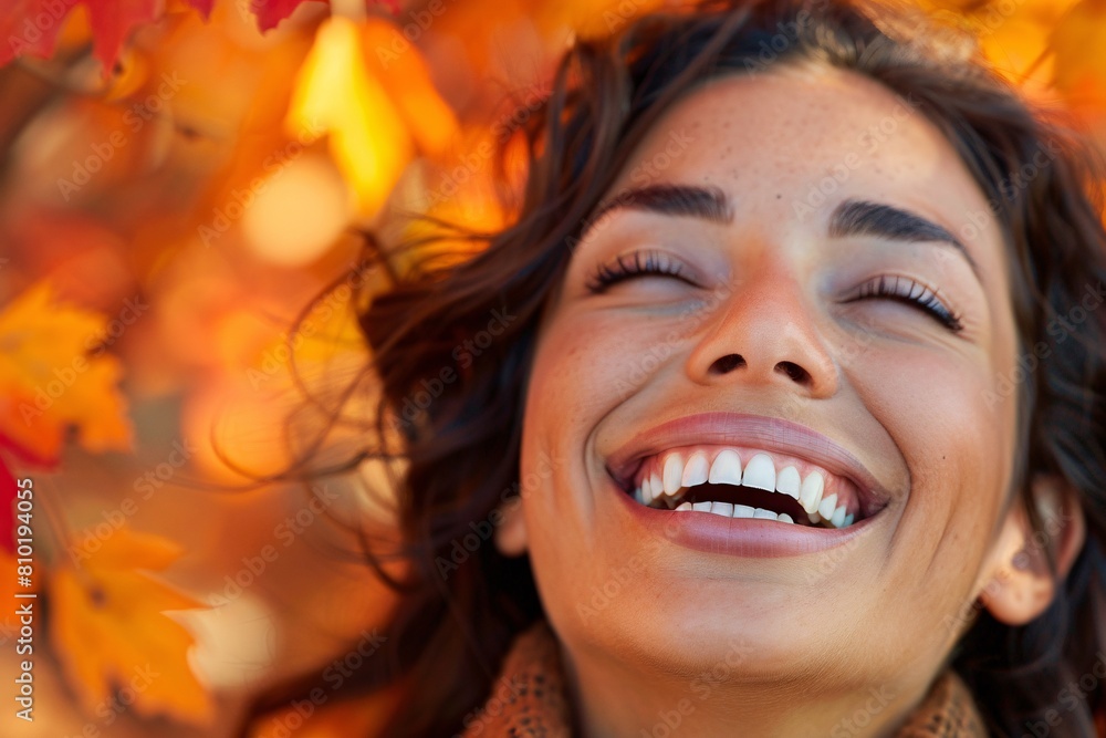 A close-up shot of a woman's face as she laughs joyfully, her eyes sparkling with happiness, with colorful autumn leaves in the background, symbolizing joy and vitality A close-up shot of a woman's face as she laughs joyfully, her eyes sparkling with happiness, with colorful autumn leaves in the background, symbolizing joy and vitality