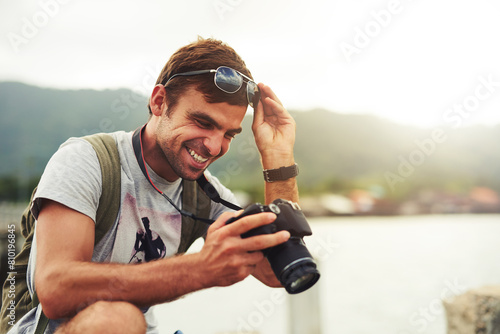 Man, camera and travel photographer at ocean as photo journalist for tourism, hobby or water. Male person, pictures and outdoor creative at sea in Australia or blog equipment, view or professional photo