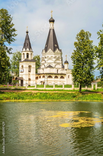 The Old Russian white tent church on the shore of the pond