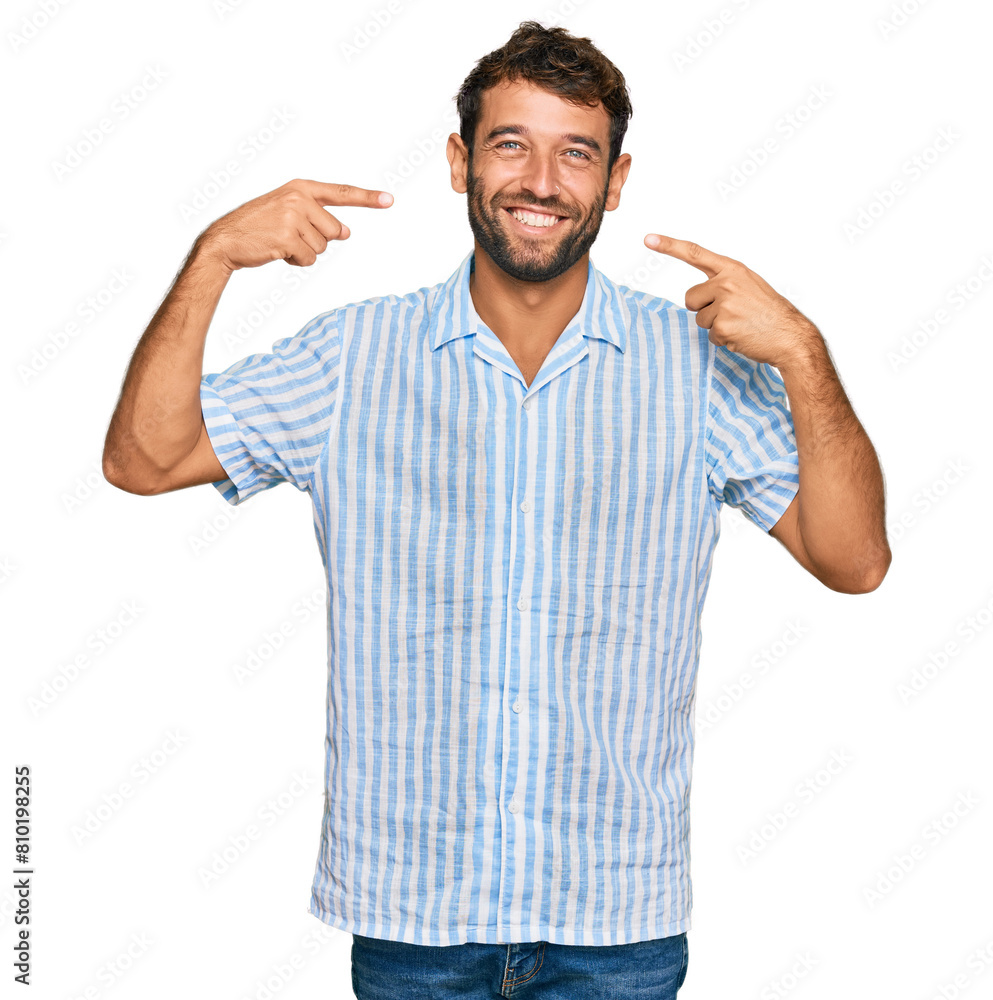 Handsome young man with beard wearing casual fresh shirt smiling cheerful showing and pointing with fingers teeth and mouth. dental health concept. Handsome young man with beard wearing casual fresh shirt smiling cheerful showing and pointing with fingers teeth and mouth. dental health concept.