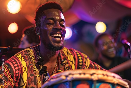A close-up of a man passionately drumming on colorful African djembe drums under the vibrant stage lights, his face illuminated with intensity and rhythm