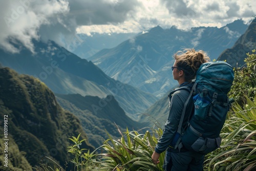 A woman with an adventurous spirit exploring a mountain trail, her face lit up with excitement and determination, with majestic peaks and lush valleys stretching as far as the eye can see