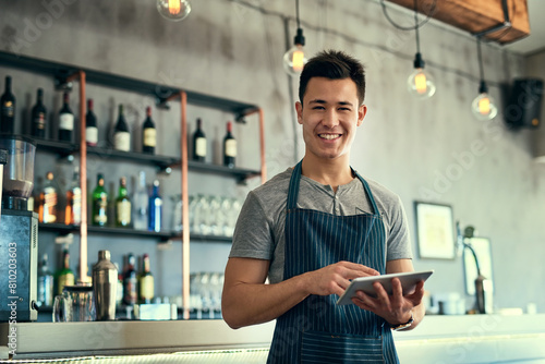 Man, tablet and barista portrait in pub, typing and waiter for online review or report and inventory order for business. Communication, planning and information search, sales and contact suppliers photo