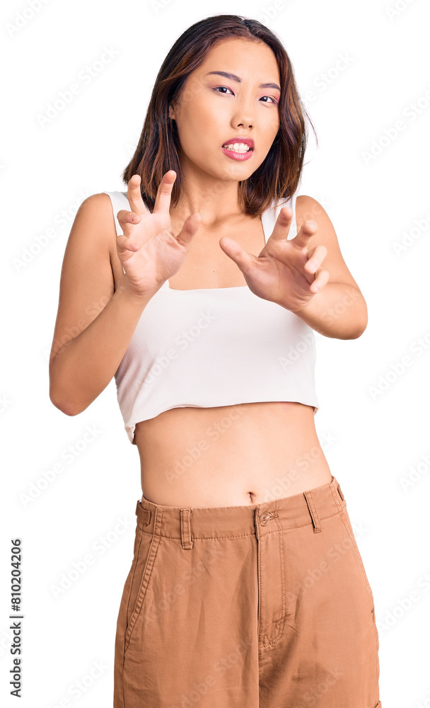Young beautiful chinese girl wearing casual clothes disgusted expression, displeased and fearful doing disgust face because aversion reaction. with hands raised Young beautiful chinese girl wearing casual clothes disgusted expression, displeased and fearful doing disgust face because aversion reaction. with hands raised