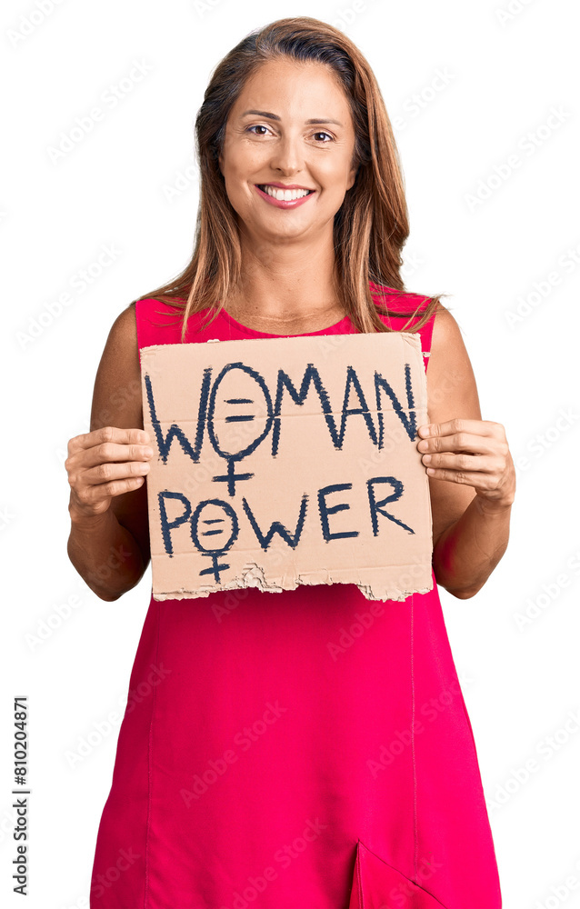 Middle age hispanic woman holding woman power banner looking positive and happy standing and smiling with a confident smile showing teeth Middle age hispanic woman holding woman power banner looking positive and happy standing and smiling with a confident smile showing teeth