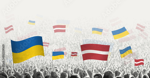 People waving flag of Latvia and Ukraine, symbolizing Latvia solidarity for Ukraine.