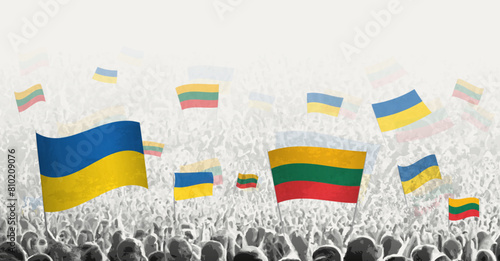People waving flag of Lithuania and Ukraine, symbolizing Lithuania solidarity for Ukraine.