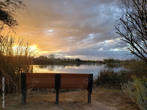 Sunset on the lake with bench