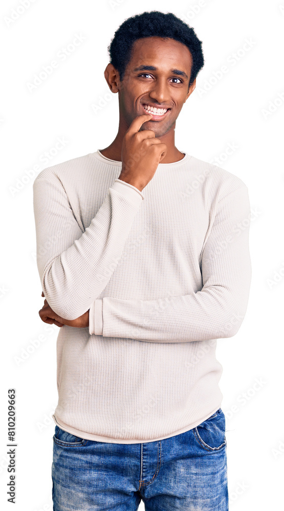 African handsome man wearing casual winter sweater looking confident at the camera with smile with crossed arms and hand raised on chin. thinking positive. African handsome man wearing casual winter sweater looking confident at the camera with smile with crossed arms and hand raised on chin. thinking positive.