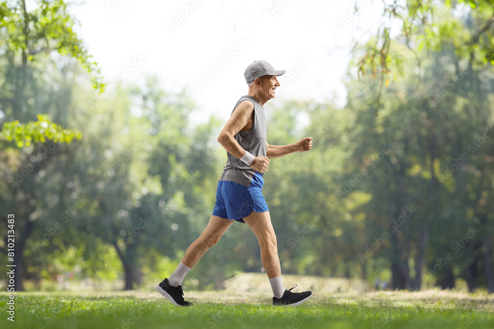 Senior man in sportswear walking in a park Senior man in sportswear walking in a park