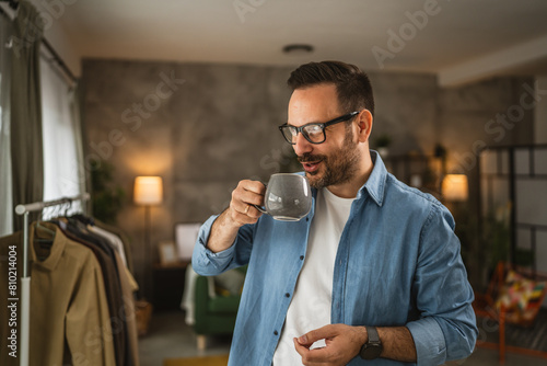 Portrait of adult caucasian man stand at home smile and hold cup
