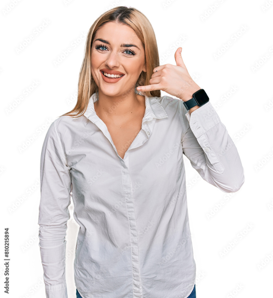 Young caucasian woman wearing casual clothes smiling doing phone gesture with hand and fingers like talking on the telephone. communicating concepts. Young caucasian woman wearing casual clothes smiling doing phone gesture with hand and fingers like talking on the telephone. communicating concepts.