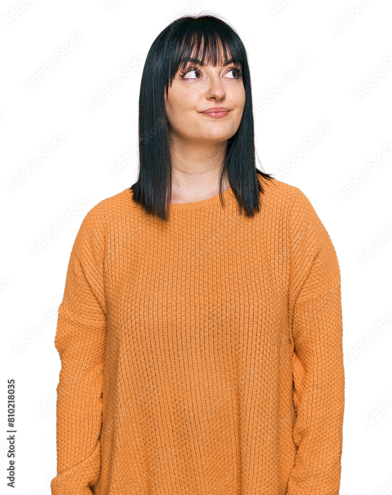 Young hispanic woman wearing casual clothes smiling looking to the side and staring away thinking. Young hispanic woman wearing casual clothes smiling looking to the side and staring away thinking.