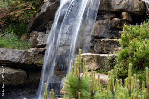 green area with a flowing waterfall in the background