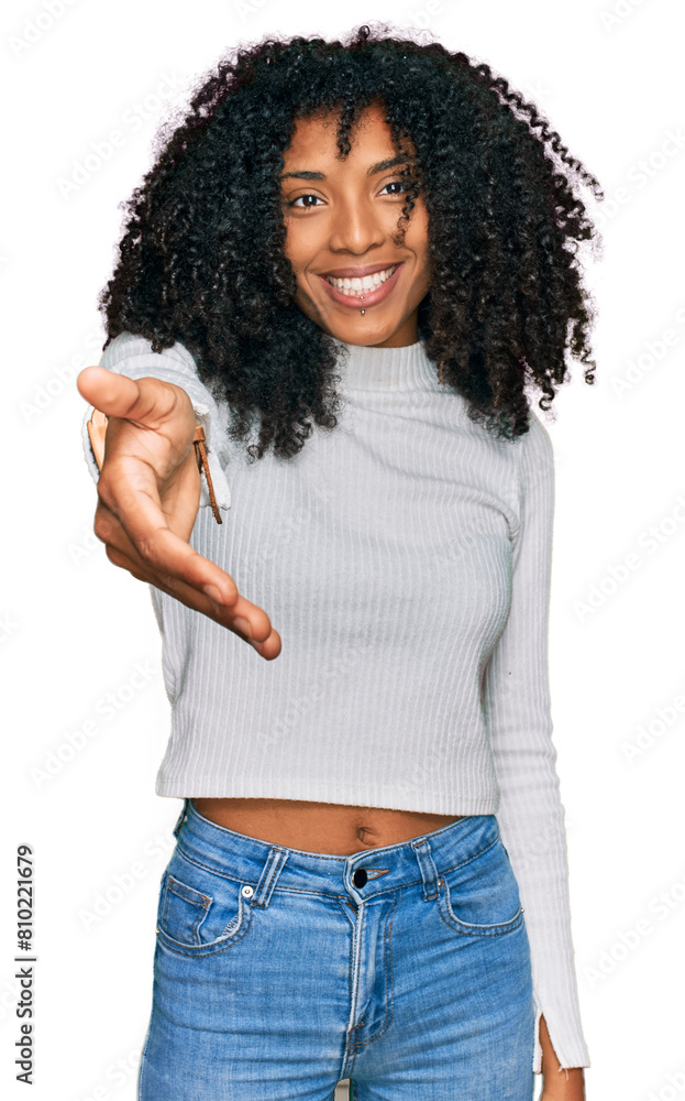 Young african american girl wearing casual clothes smiling cheerful offering palm hand giving assistance and acceptance. Young african american girl wearing casual clothes smiling cheerful offering palm hand giving assistance and acceptance.