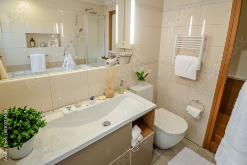 Bright and airy modern bathroom with ceramic  towels  bathtub  and green plant for a fresh and comfortable atmosphere