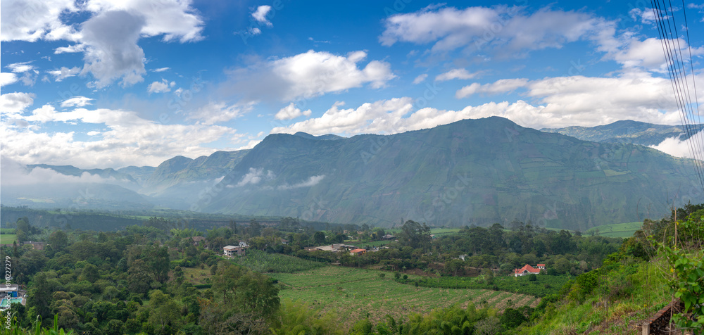 Panoramic photo of country houses and crops in a foggy mountain landscape in Colombia. Panoramic photo of country houses and crops in a foggy mountain landscape in Colombia.
