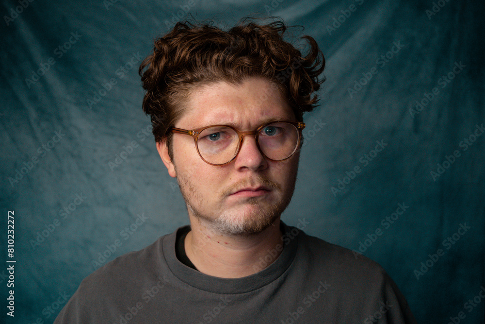 Obraz premium Man with Glasses Angry Portrait with Blue Background.