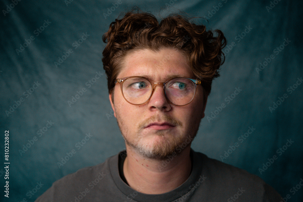 Obraz premium Man with Glasses Confused Portrait with Blue Background.