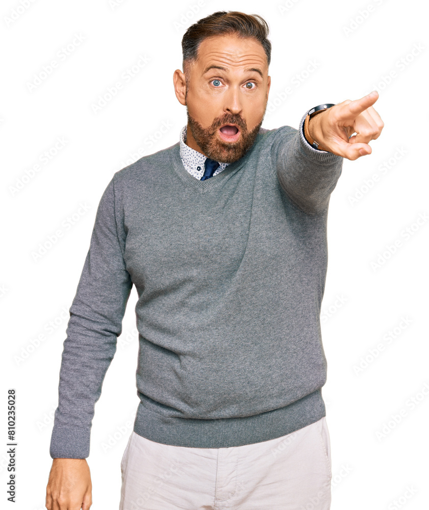 Naklejka premium Handsome middle age man wearing business clothes pointing with finger surprised ahead, open mouth amazed expression, something on the front