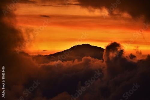 Silhouette of Mount Meru, a dormant stratovolcano and the second highest mountain in Tanzania (4562 m), as observed at dusk from the vicinity of Shira Camp on Mount Kilimanjaro (Tanzania, Africa) photo