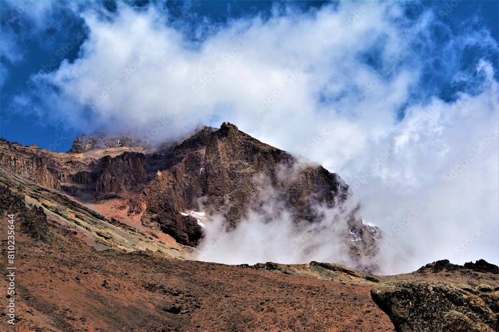 Kibo volcanic cone with Uhuru Peak (5895 m) on its rim as seen from the part of hiking trail (Machame or 
