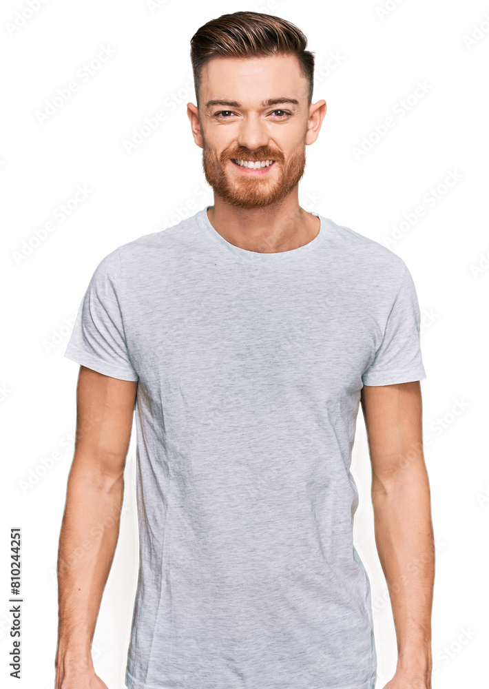 Young redhead man wearing casual grey t shirt with a happy and cool smile on face. lucky person. Young redhead man wearing casual grey t shirt with a happy and cool smile on face. lucky person.