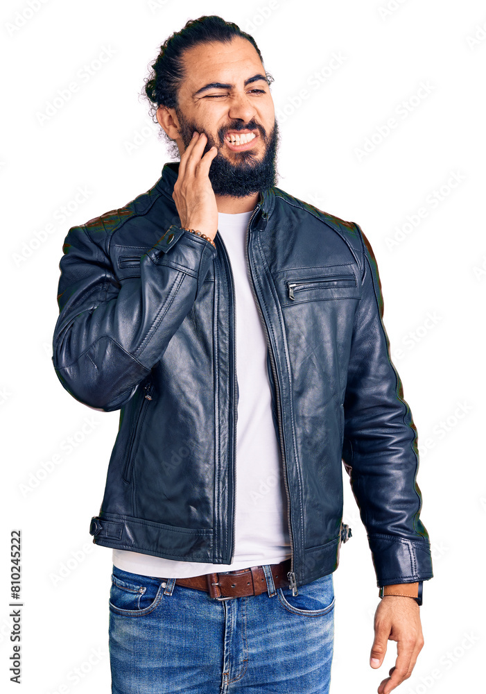 Young arab man wearing casual leather jacket touching mouth with hand with painful expression because of toothache or dental illness on teeth. dentist Young arab man wearing casual leather jacket touching mouth with hand with painful expression because of toothache or dental illness on teeth. dentist