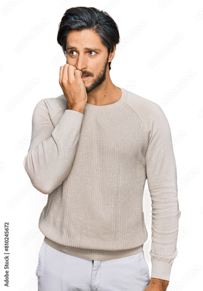 Young hispanic man wearing casual clothes looking stressed and nervous with hands on mouth biting nails. anxiety problem. Young hispanic man wearing casual clothes looking stressed and nervous with hands on mouth biting nails. anxiety problem.