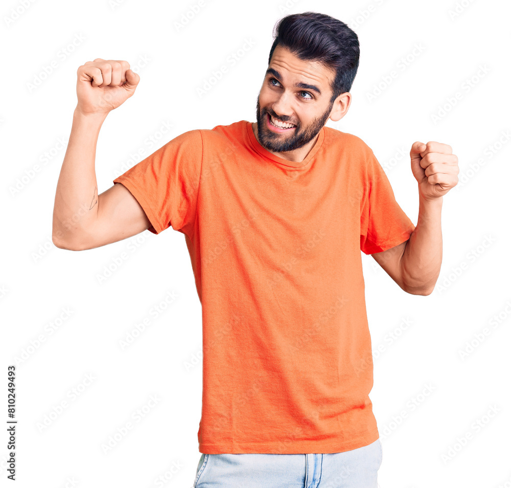 Young handsome man with beard wearing casual t-shirt dancing happy and cheerful, smiling moving casual and confident listening to music Young handsome man with beard wearing casual t-shirt dancing happy and cheerful, smiling moving casual and confident listening to music