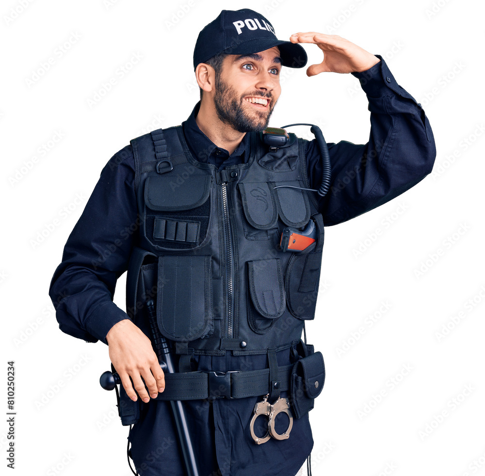 Young handsome man with beard wearing police uniform very happy and smiling looking far away with hand over head. searching concept. Young handsome man with beard wearing police uniform very happy and smiling looking far away with hand over head. searching concept.