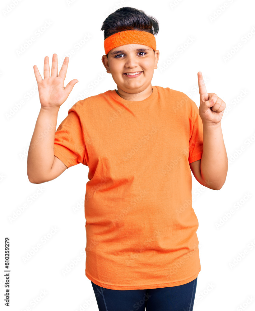 Little boy kid wearing sportswear showing and pointing up with fingers number six while smiling confident and happy. Little boy kid wearing sportswear showing and pointing up with fingers number six while smiling confident and happy.