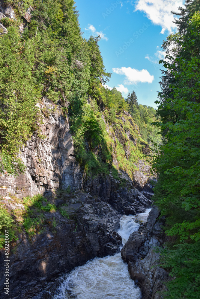 View of a narrow gorge at Canyon Sainte-Anne with flowing water in Quebec Canada