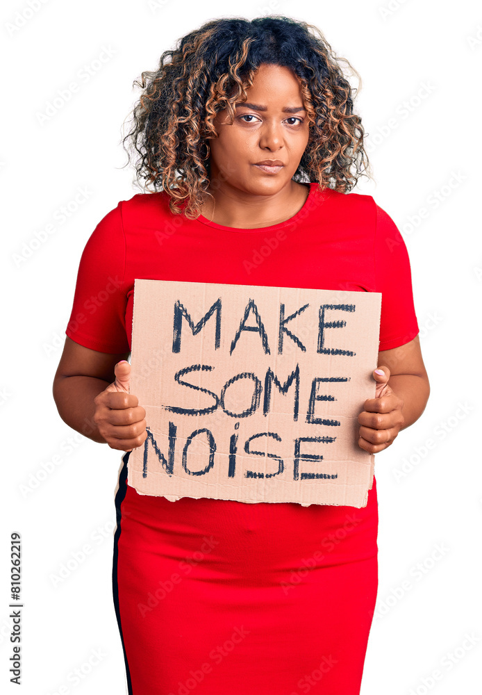 Young african american plus size woman holding make some noise banner thinking attitude and sober expression looking self confident Young african american plus size woman holding make some noise banner thinking attitude and sober expression looking self confident