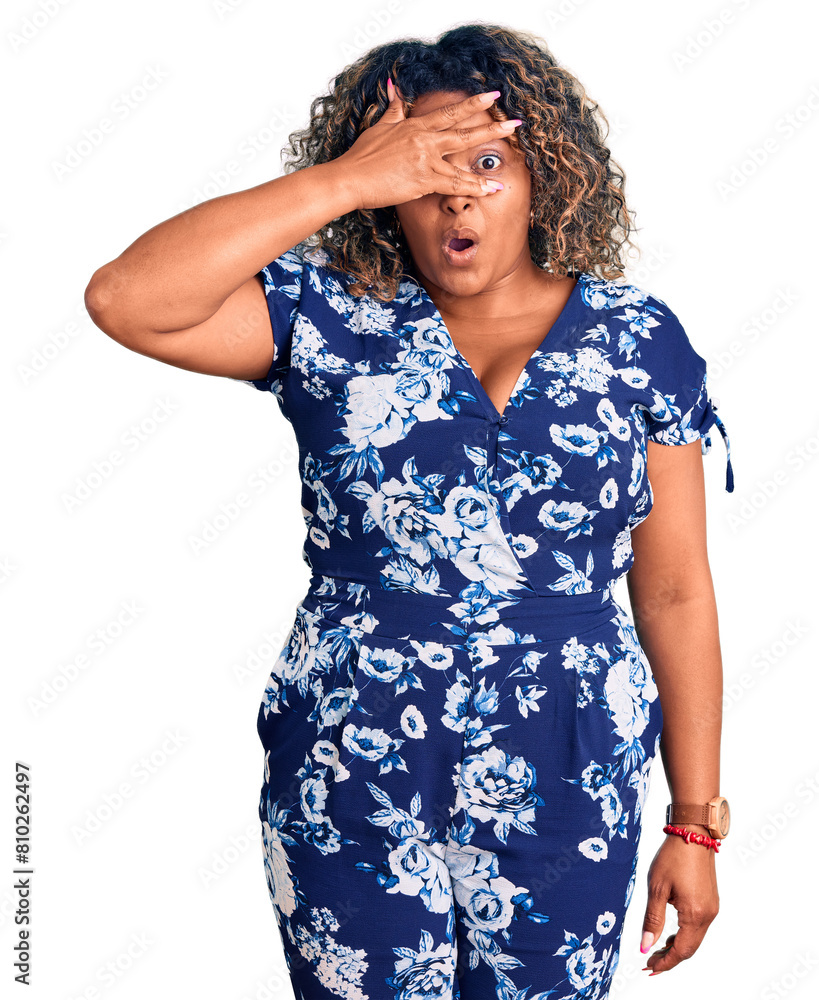 Young african american plus size woman wearing casual clothes peeking in shock covering face and eyes with hand, looking through fingers with embarrassed expression. Young african american plus size woman wearing casual clothes peeking in shock covering face and eyes with hand, looking through fingers with embarrassed expression.
