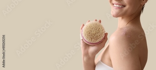Young woman scrubbing body ...