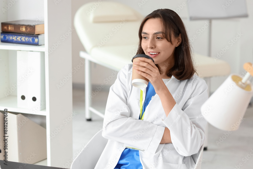 Female doctor with coffee cup in clinic Female doctor with coffee cup in clinic
