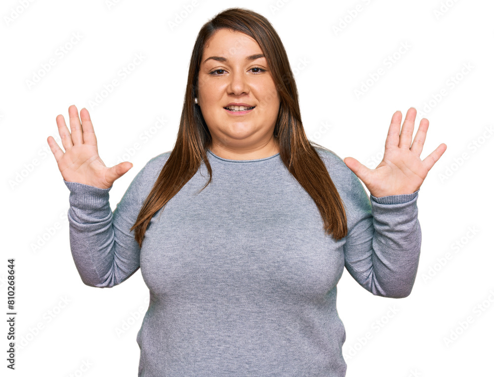 Beautiful brunette plus size woman wearing casual clothes showing and pointing up with fingers number ten while smiling confident and happy. Beautiful brunette plus size woman wearing casual clothes showing and pointing up with fingers number ten while smiling confident and happy.