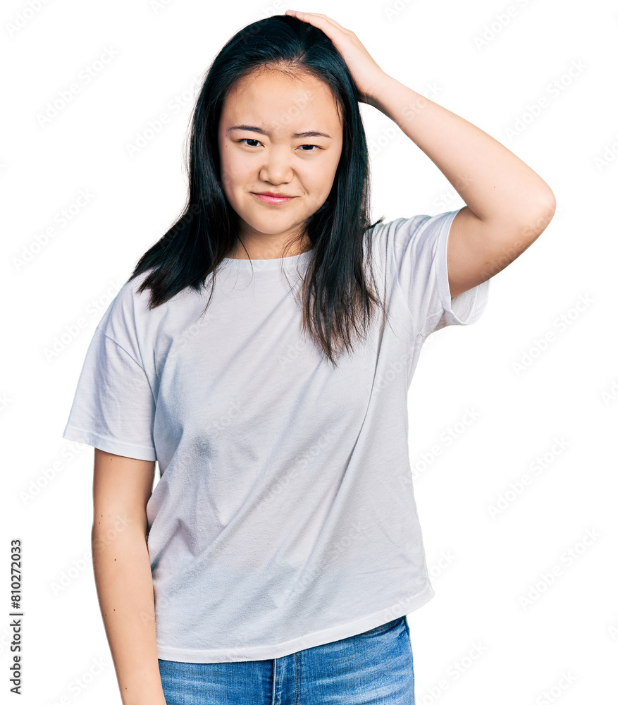 Young chinese woman wearing casual white t shirt confuse and wonder about question. uncertain with doubt, thinking with hand on head. pensive concept. Young chinese woman wearing casual white t shirt confuse and wonder about question. uncertain with doubt, thinking with hand on head. pensive concept.