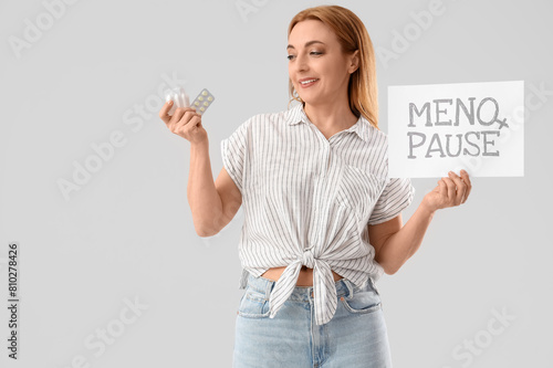 Mature woman holding paper ...
