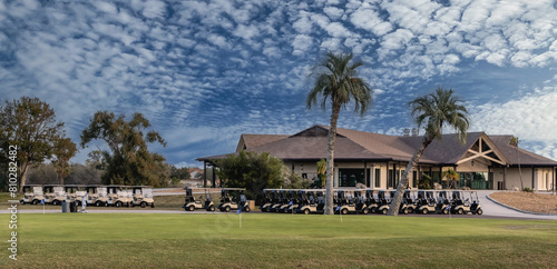 Fotografie Multiple golf carts parked  outside clubhouse