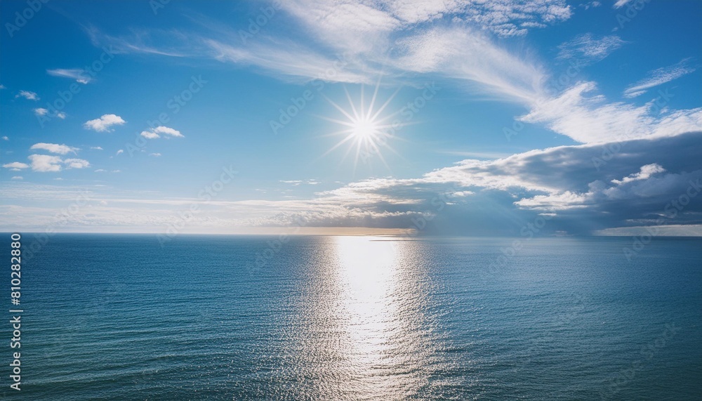 bright blue sky with sun over the ocean water
