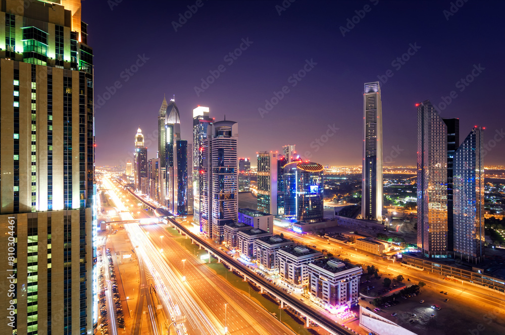 Stunning night view of a vibrant city's skyline and busy highways, illuminating the dusk