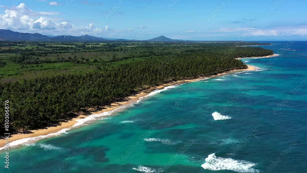 A Pristine and Deserted Beach Landscape on the East Coast of the Dominican Republic with Turquoise-coloured Sea and a Golden Beach Lined with Coconut Palms. A Pristine and Deserted Beach Landscape on the East Coast of the Dominican Republic with Turquoise-coloured Sea and a Golden Beach Lined with Coconut Palms.