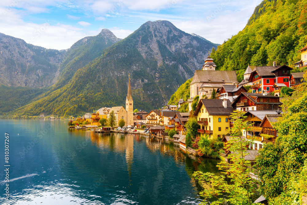 Fototapeta premium The picturesque lakefront townscape with homes and towers above the Tyrolian village of Hallstatt, Austria, a village on Lake Hallstatt's western shore in Austria's mountainous Salzkammergut region.